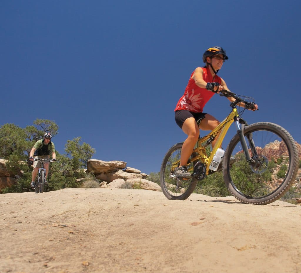 A mountain biker enjoys her ride on a trail in arizona.